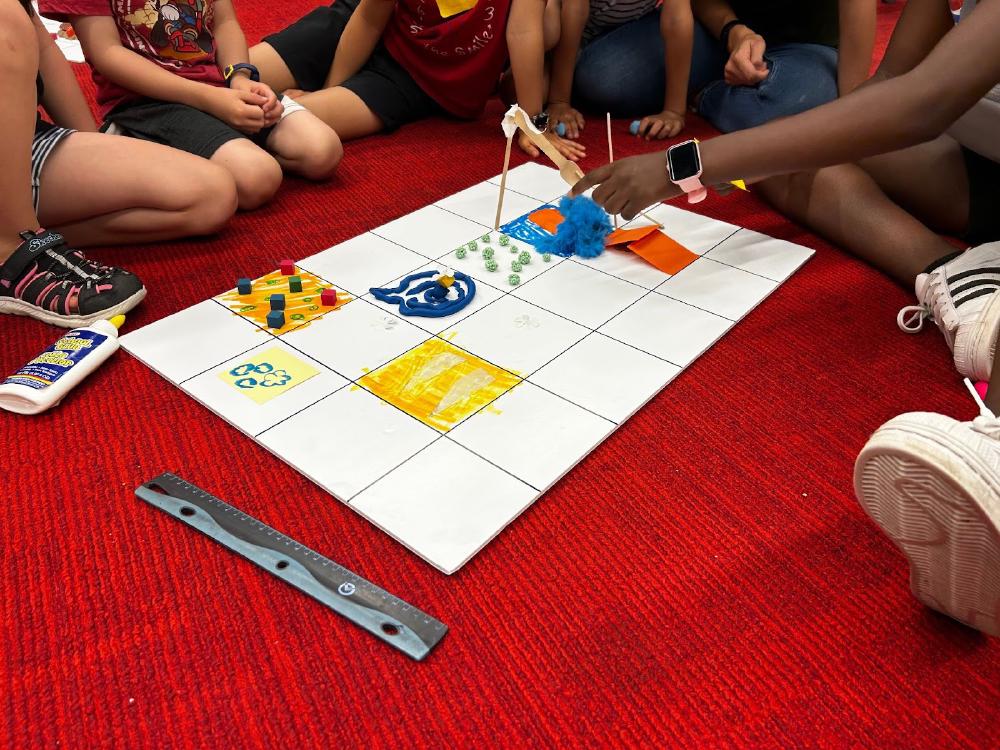 Facilitators conducting offline coding exercise on building instruction sequences.