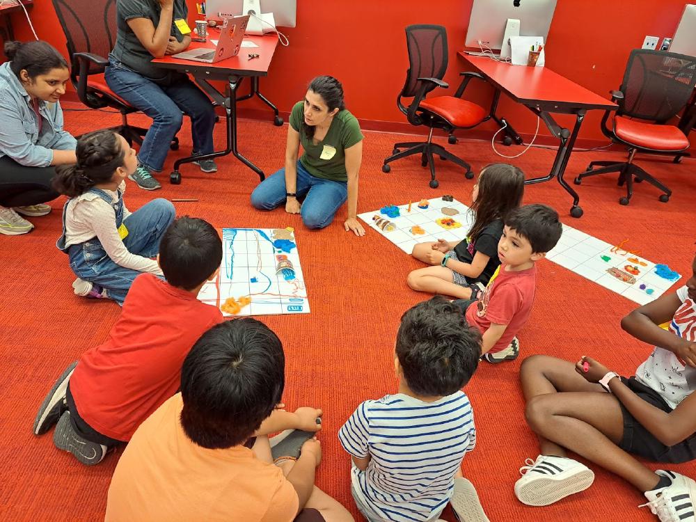 Participants creating custom backgrounds on bristol boards.